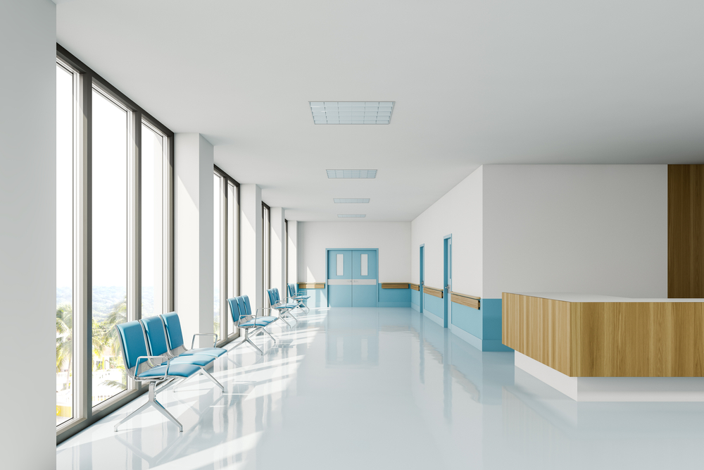 Featured image showing a modern hospital hallway with occupancy sensors hooked up to the lights for efficiency